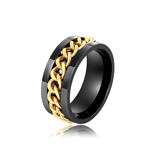 Close-up of hip-hop style rotating gold chain inlay on a matte black stainless steel ring