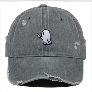 Detail of distressed baseball cap with ghost embroidery and vintage frayed texture