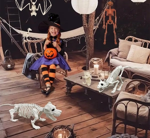 Realistic white animal bone skeletons and pumpkin head decors in a spooky garden setup