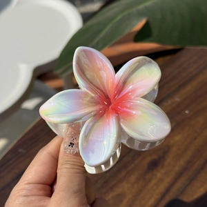 Iridescent white plumeria flower hair claw clip with pearlescent finish for high ponytail