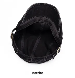 Internal view of black washed denim beret showing stitching and metal adjustment buckle