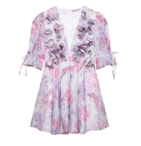 Detailed view of 3D fabric flower decorations on a lilac V-neck mini dress