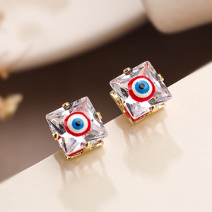 Macro detail of square evil eye stud earrings with 18K gold plating and colorful zircon