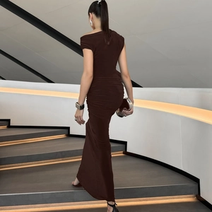 Detail of elegant dark brown ruched maxi dress with open back and mermaid hemline