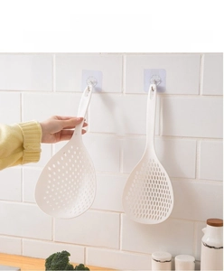Macro detail of white nylon food strainer with long ergonomic handle and hanging hole