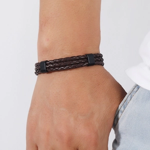 Vintage multi-layer woven brown leather bracelet with black metal clasp on wrist