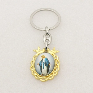 Detailed close-up of Virgin Mary charm keychain with golden woven frame and silver ring