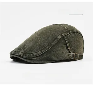 Detail of army green washed cotton flat cap with adjustable bronze metal side buckle