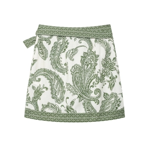 Detail of off-white paisley print mini skirt with matching belt and tiered hemline