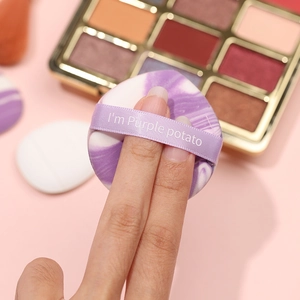 Purple marble pattern finger puff with ribbon handle for detailed makeup application