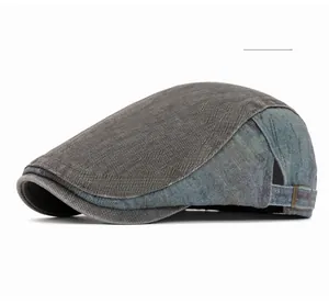 Detail view of denim patchwork newsboy cap with vintage metal adjustable brass buckle