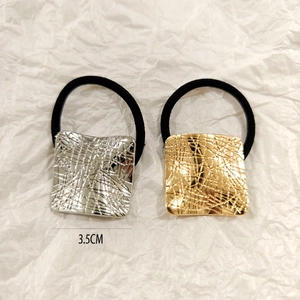 Detail of 3.5cm gold and silver hollow square hair ties with black elastic bands