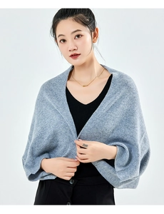 Detailed texture of gray cashmere knit shawl cardigan with soft wool yarn on a model
