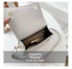 Internal capacity of the white crossbody bag showing storage space for phone and makeup