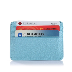 Detailed view of light blue litchi textured leather card holder with three card slots