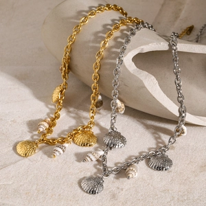 Detail of 18k gold and silver starfish shell charms on thick link stainless steel chain