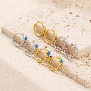 Macro view of minimalist S925 silver hoop earrings with inset opal in gold and silver