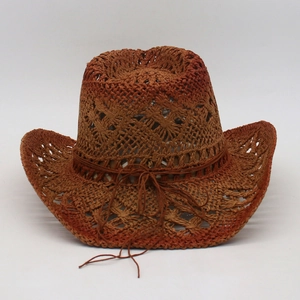 Detailed weave pattern on a tan straw cowboy sun hat with a decorative ribbon bow