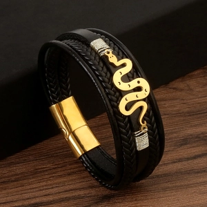 Detail of multi-layer black braided leather bracelet with golden snake ornament and clasp