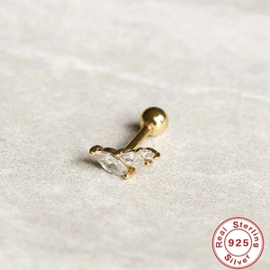 Macro shot of gold S925 sterling silver paw earring with sparkling zircon stones