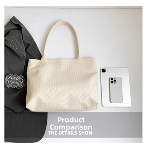 Top-down view of a beige woven leather tote bag showing large capacity and interior space