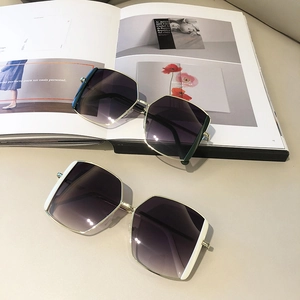 Chic square sunglasses with gold metal frames and gradient lenses on a lifestyle magazine