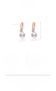 Macro view of rose gold pearl earrings with dimensions 26.3mm by 9.8mm and zircon inlay