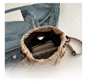 Interior view of beige nylon drawstring bag showing phone and wallet storage space