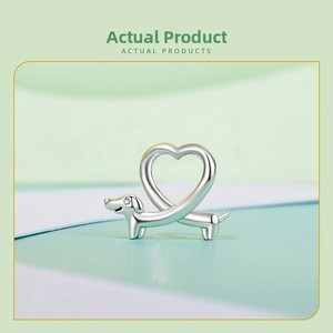 Macro shot of 925 silver dachshund dog charm featuring a heart-shaped tail and zircon eye