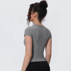 Close-up of the tailored seams and breathable gray heather fabric on a slim yoga tee