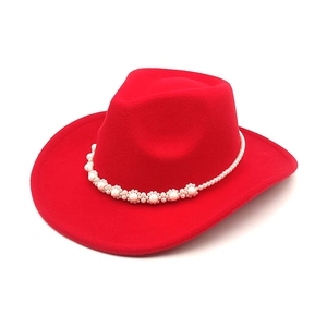 Detail of red wool felt cowboy hat with decorative white pearl beaded hatband