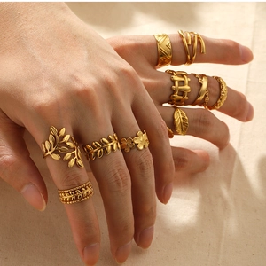Detail of 18k gold-plated rings set featuring leaf, flower, and geometric relief patterns