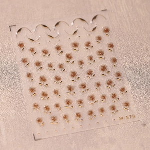 Detailed close-up of M-578 nail stickers featuring brown roses and golden leaf accents