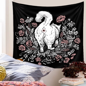 Detailed view of black tapestry featuring a white cat outline and floral wall decoration
