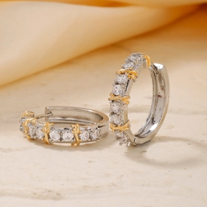 Macro shot of two-tone gold and silver earrings featuring micro-pave zircon crystals