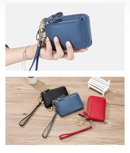Litchi pattern leather coin purses in black, blue and red with wrist straps on wood background