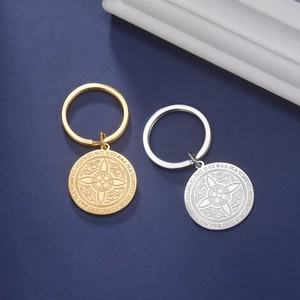 Detail of gold and silver stainless steel keychains with Celtic knot engraving