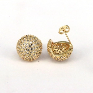 Detailed view of gold plated spherical stud earrings with micro paved clear cubic zirconia