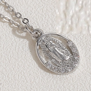 Close-up of Virgin Mary silver pendant with sparkling zircon micro-pave detailing