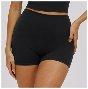 Close-up of black high-waist yoga shorts showing seamless elastic fabric and tummy control