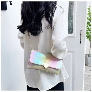 Close-up of laser holographic heart purse with gold chain strap and metal heart buckle