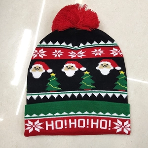 Detailed view of jacquard knitted Christmas hat with pompom and HO HO HO text