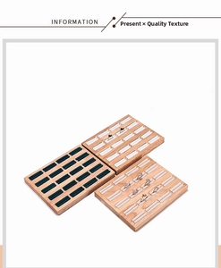Top view of wooden jewelry trays with three colors of velvet inserts for ring display