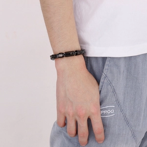 Close-up of black stainless steel paperclip chain bracelet on a male model wrist