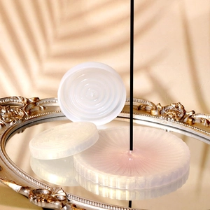 Macro detail of round silicone molds and pearl pink resin incense burner tray