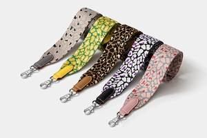 Detailed view of five leopard print woven shoulder straps with silver metal clasps