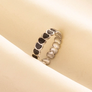 Close-up of adjustable silver steel ring featuring black drip oil heart patterns