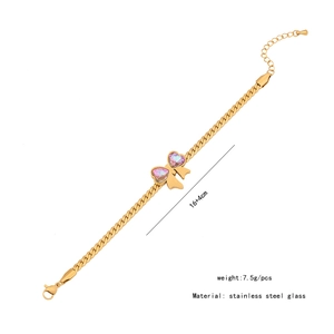 Detail of golden stainless steel bracelet with purple heart-shaped glass bow centerpiece