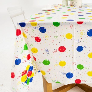 White disposable party tablecloth with colorful balloons and Happy Birthday lettering