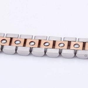 Macro detail of two-tone brushed titanium steel link bracelet with inlaid germanium stones